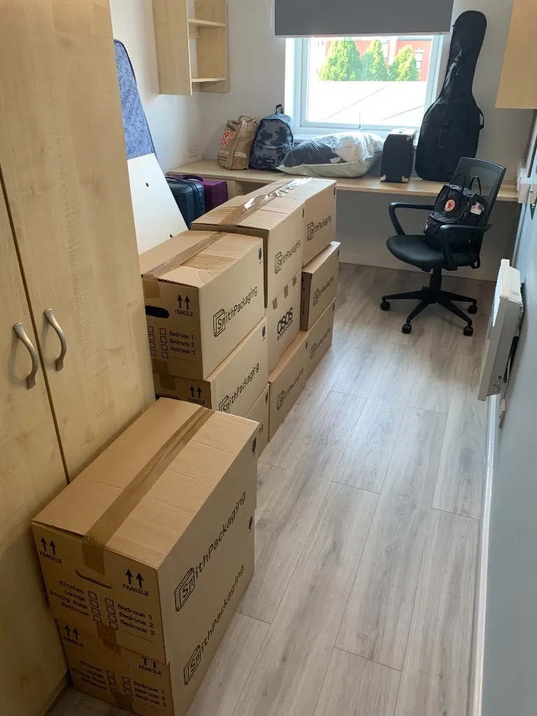 Stacked moving boxes in a room